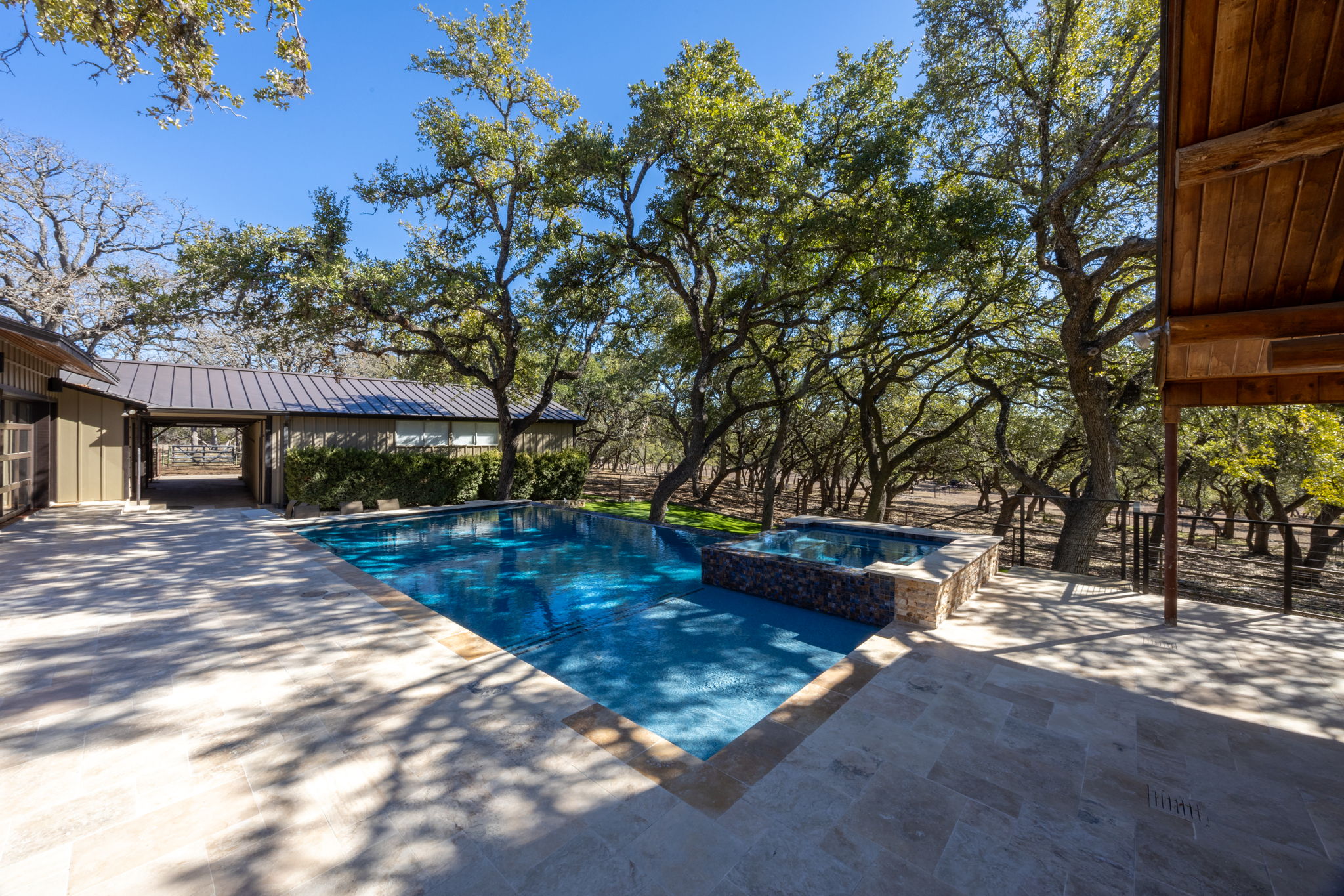 Elegant pool with beautiful landscaping and stone features