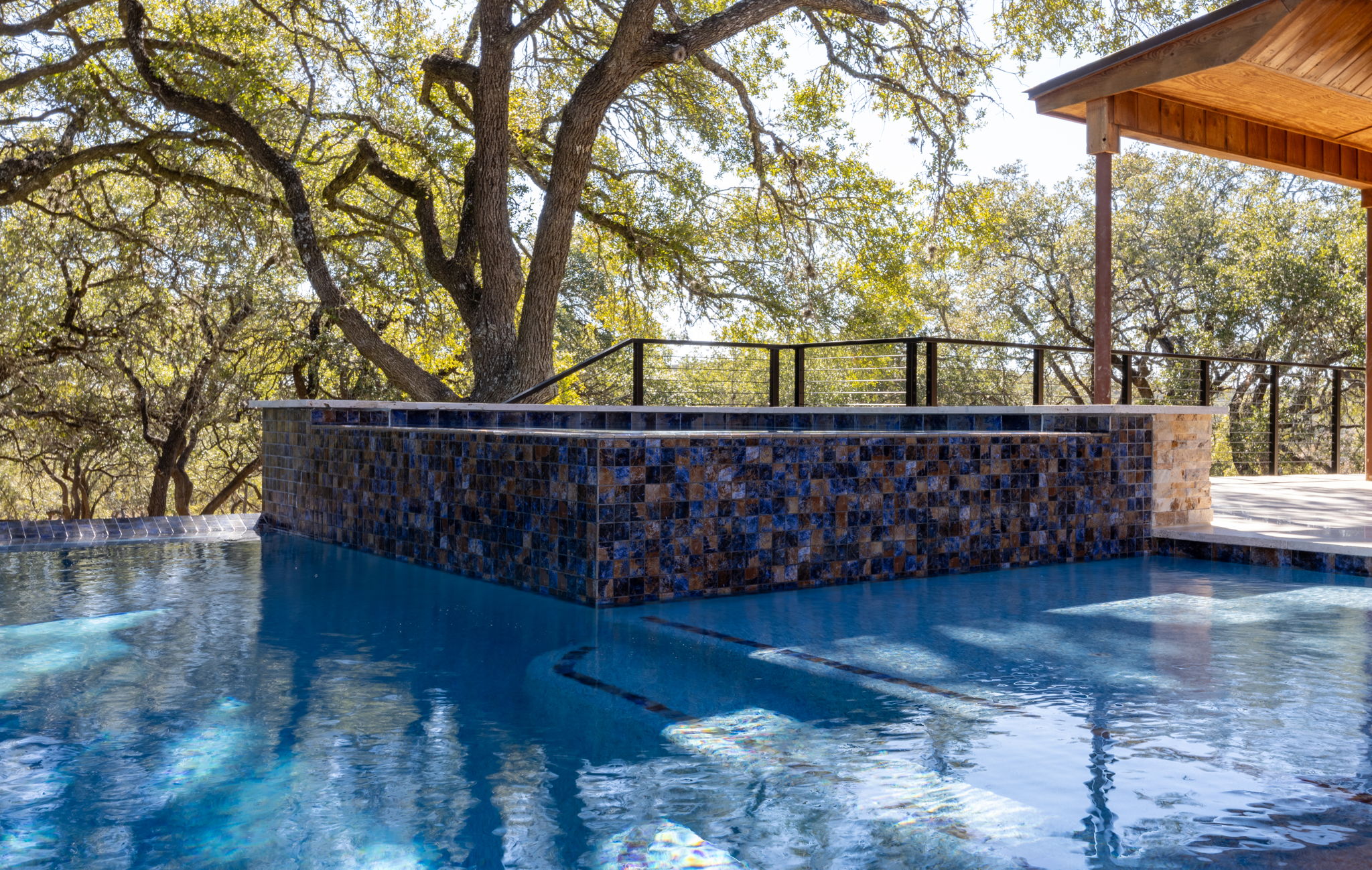 Custom pool with integrated spa and water features