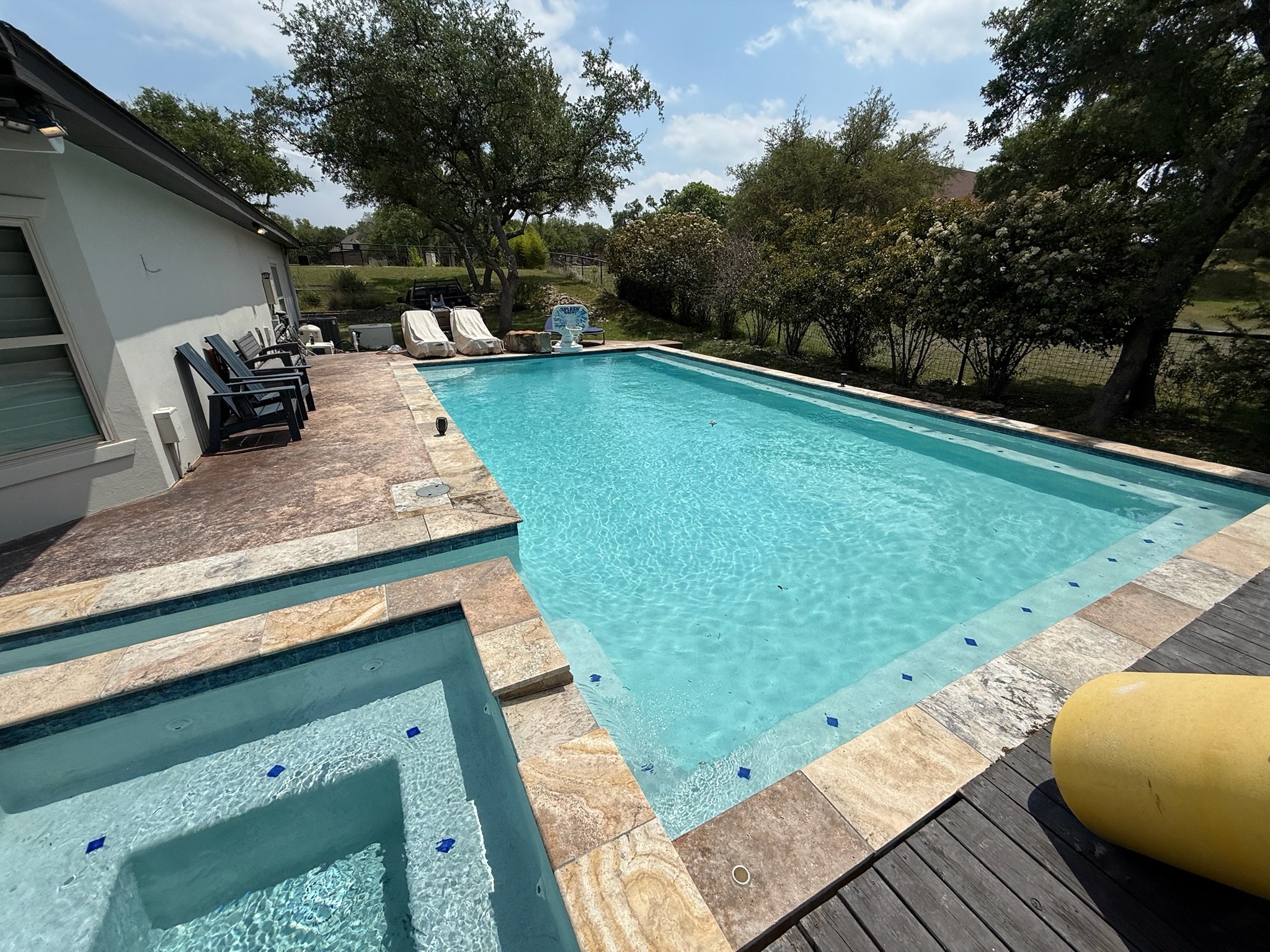 Rectangular Spring Branch pool with corner spa, natural stone coping and spacious patio